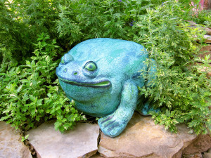 A whimsical verdigris bullfrog offers an element of surprise as well as textural contrast with the ferny plants.